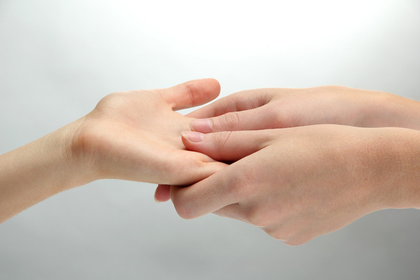 Hand massage, on grey background - Foto, afbeelding