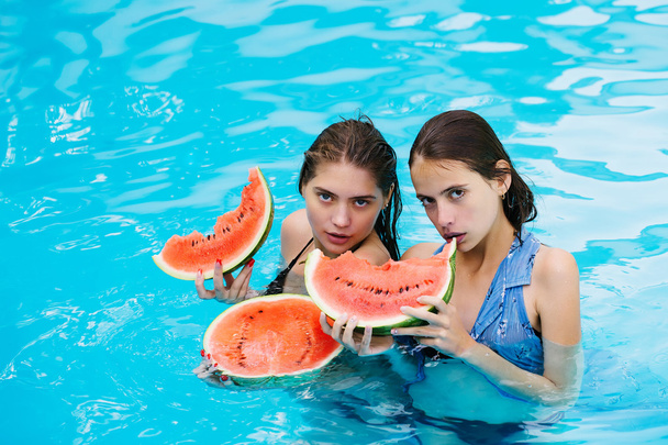 women with watermelon in swimming pool - Foto, imagen
