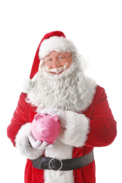 Santa Claus holding piggy bank on white background - Zdjęcie, obraz