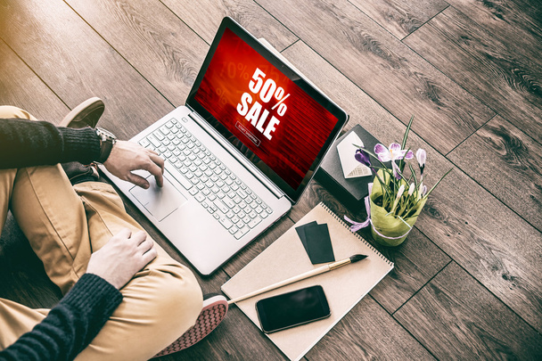 Sale Shopping concept. Young Businessman using Laptop sitting on the floor - Fotografie, Obrázek