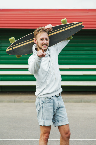Sanguine hipster man with longboard - Foto, Imagem