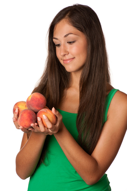 Pretty smiling woman with red peaches - Zdjęcie, obraz