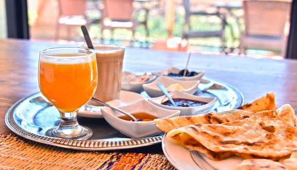Moroccan breakfast served on hotel terace in Atlas Mountains - Photo, Image