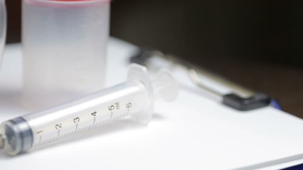 Medical test kit. syringe glasses and jar for tests - Séquence, vidéo