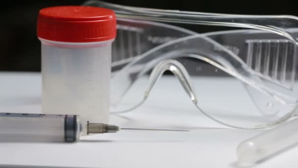 Medical test kit. syringe glasses and jar for tests - Video, Çekim