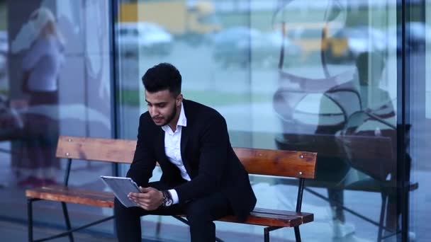 Man in Suit Arabic Puts on Sunglasses With Tablet Near Business - Footage, Video