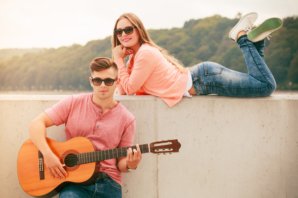 Happy couple with guitar outdoor - Photo, Image