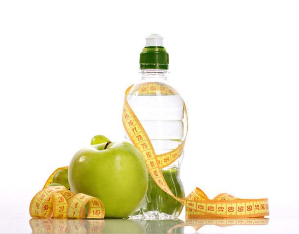 green apple, bottle with aqua and small grapes - Foto, Imagem