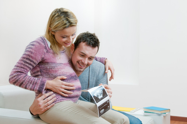 Happy pregnant young couple with baby sonogram - Fotografie, Obrázek