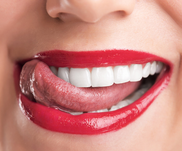 Licking lips. Young woman licking lips. - Foto, Imagen