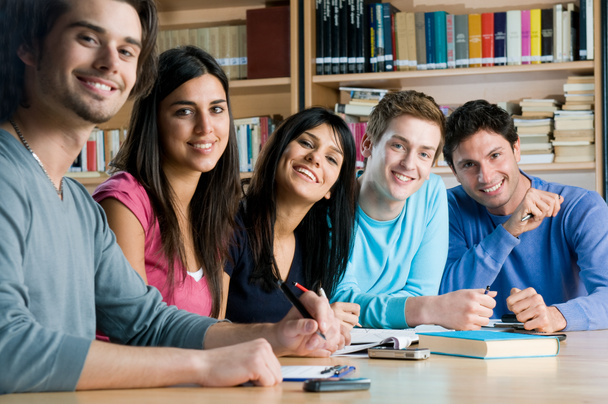 Smiling group of students in a library - Photo, Image