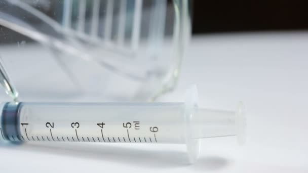 Medical test kit. syringe glasses and jar for tests - Кадры, видео