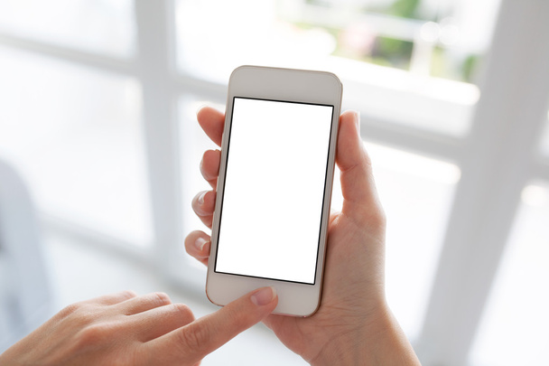 Women hands holding white phone with isolated screen background  - Foto, afbeelding