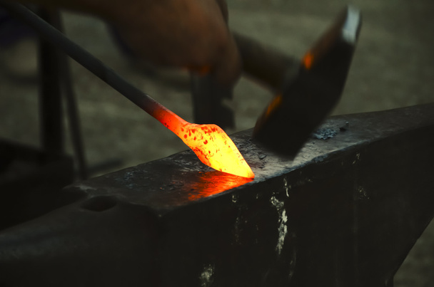 Blacksmith forging a metal pin - Photo, Image