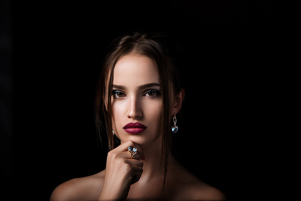 Beauty portrait of girl with jewelry on black background - Foto, imagen