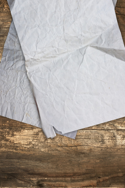 Crumpled old papers on a wooden background - Photo, Image