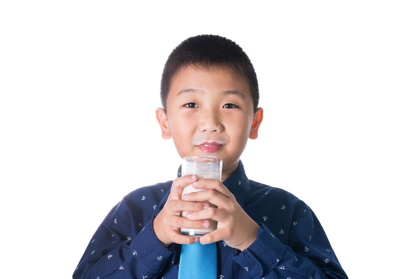 Boy drinking milk with milk mustache holding glass of milk isola - Foto, Bild