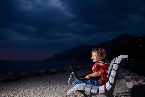 cute boy with laptop on beach - Фото, зображення