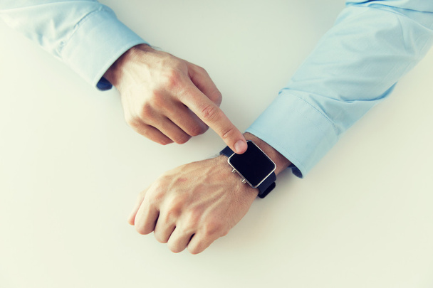 close up of male hands setting smart watch - Foto, Imagen