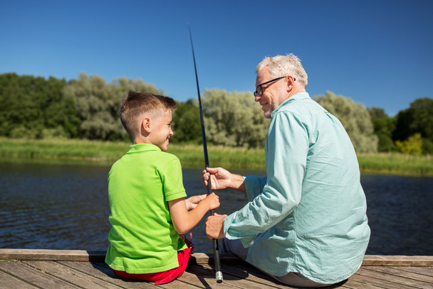 grandfather and grandson fishing on river berth - Zdjęcie, obraz