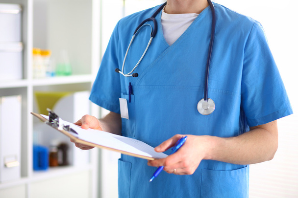 Closeup portrait of a doctor with stethoscope holding folder - Foto, Bild