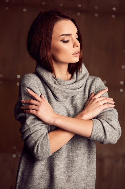 Portrait of young woman in grey dress in studio - Foto, imagen