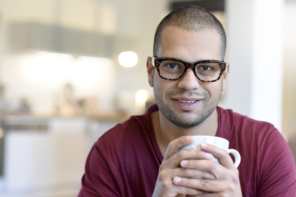  hispanic guy with eyeglasses on drinking tea - Zdjęcie, obraz