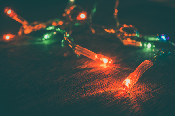 christmas light  on wood background , Soft focus and vintage ton - Foto, afbeelding