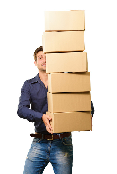 Un joven sosteniendo una pila de cajas de cartón
 - Foto, imagen