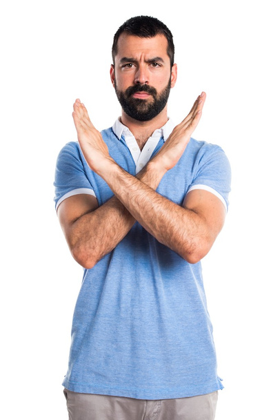 Man with blue shirt doing NO gesture - Foto, Imagen
