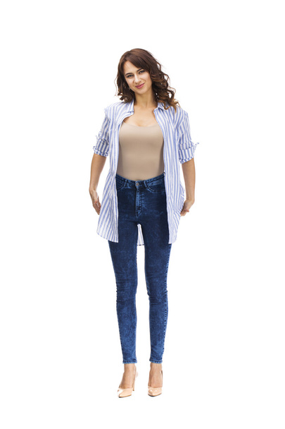Young beautiful brunette woman in blue jeans  - Фото, изображение