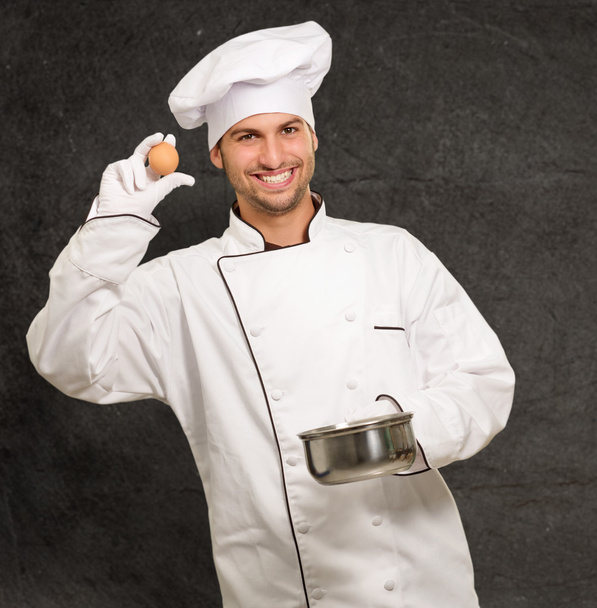 Male Chef Holding A Pot And Egg - Foto, imagen