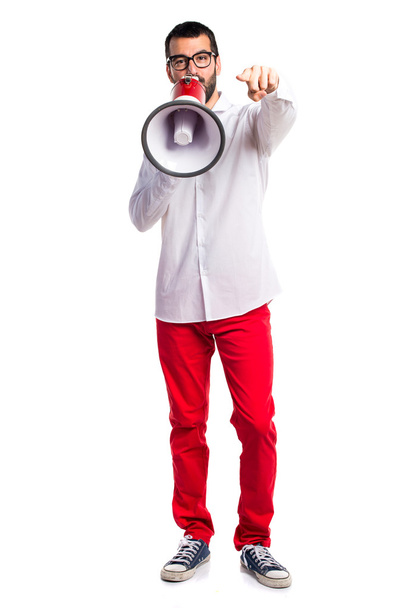 Handsome man with glasses shouting by megaphone - Foto, Imagen