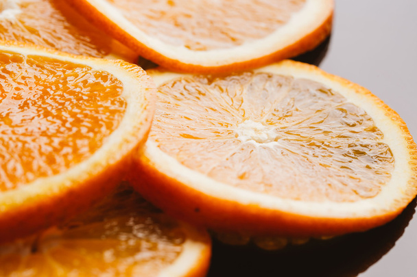 sliced orange halves on a dark background closeup - Foto, Imagen