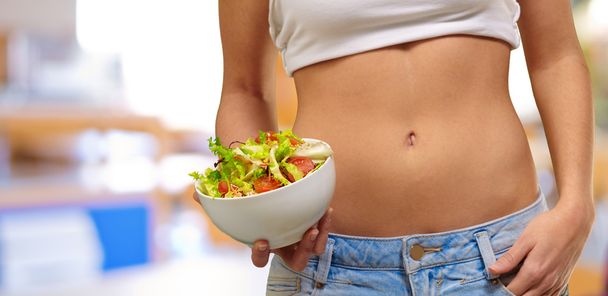 Female Holding A Bowl Of Salad - Foto, afbeelding