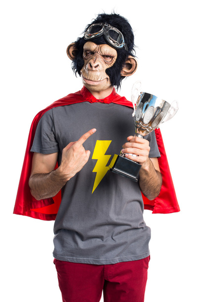 Hombre mono superhéroe sosteniendo un trofeo
 - Foto, imagen