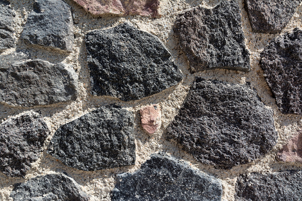 Primo piano del muro di pietra vulcanica a Santorini, Grecia
 - Foto, immagini