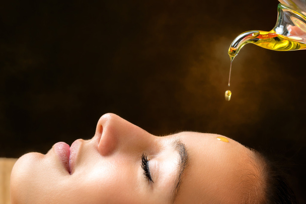 Aromatic oil dripping on female face. - Photo, Image