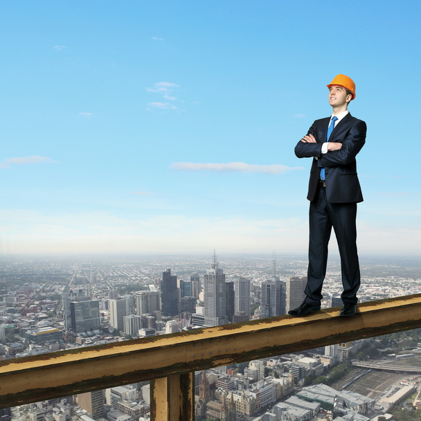 Businessman standing on the construction site - Foto, imagen