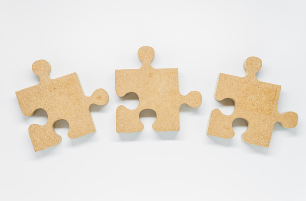 Three pieces of wooden puzzle on white background - Fotografie, Obrázek