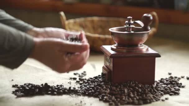 Woman puts coffee beans in an antique coffee grinder. Slow motion - Imágenes, Vídeo