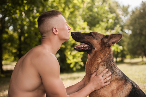 athletic man and dog - Фото, изображение