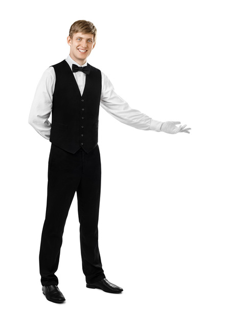handsome waiter doing a welcome gesture - Фото, изображение