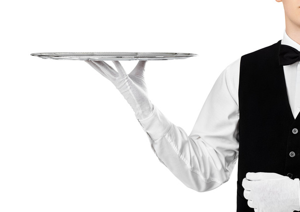 Elegant waiter holding silver tray - Fotó, kép
