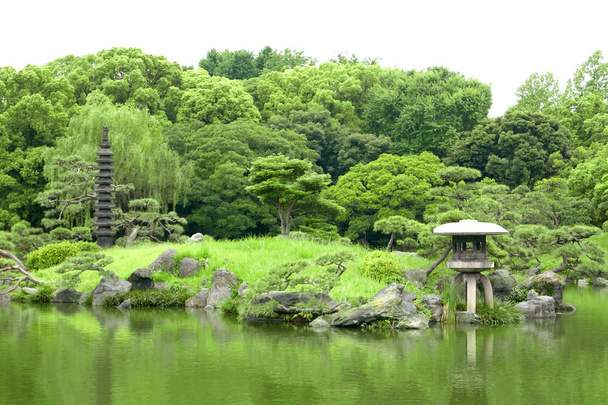 Japanese outdoor stone lantern and lake in zen garden - Photo, Image