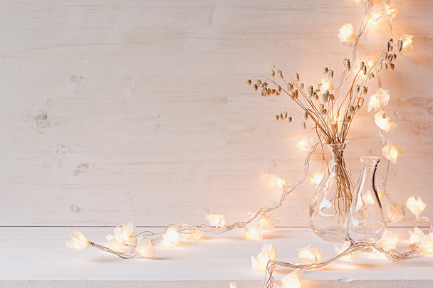 Burning lights and decoration on white wooden background.  - Фото, изображение