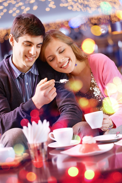 Happy couple eating dessert in cafe - Photo, Image