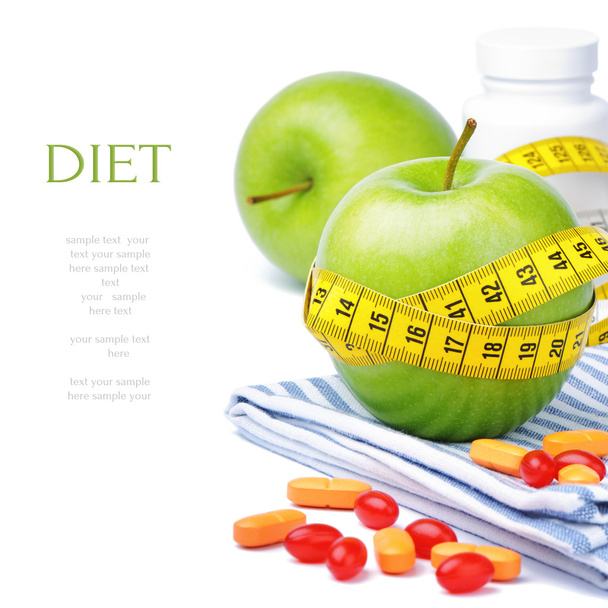 Green apples, vitamins and measuring tape - Photo, Image