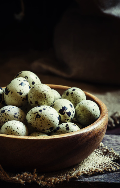 Quail eggs, old wooden background - Foto, afbeelding