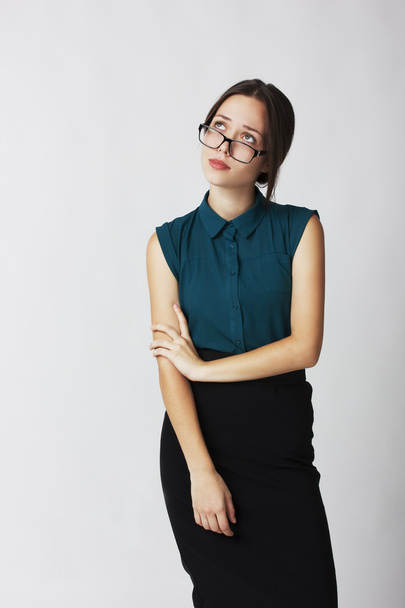 Young business woman in glasses, looks up wearily - 写真・画像